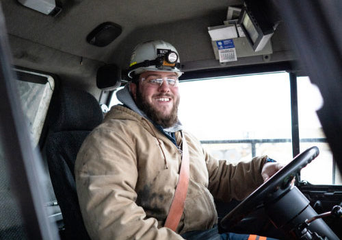 North American Coal Employee Wearing Hard Hat, Safety Glasses & Operating Equipment