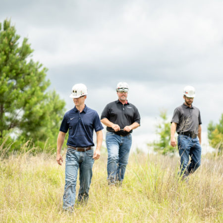 NA Coal Members Walking at Job Site in Hard Hats